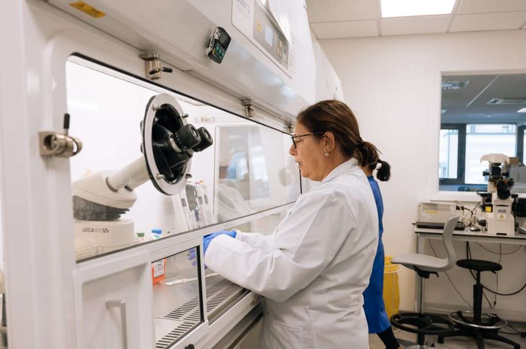 Scientist on a lab tour, being shown a lab equipment and process