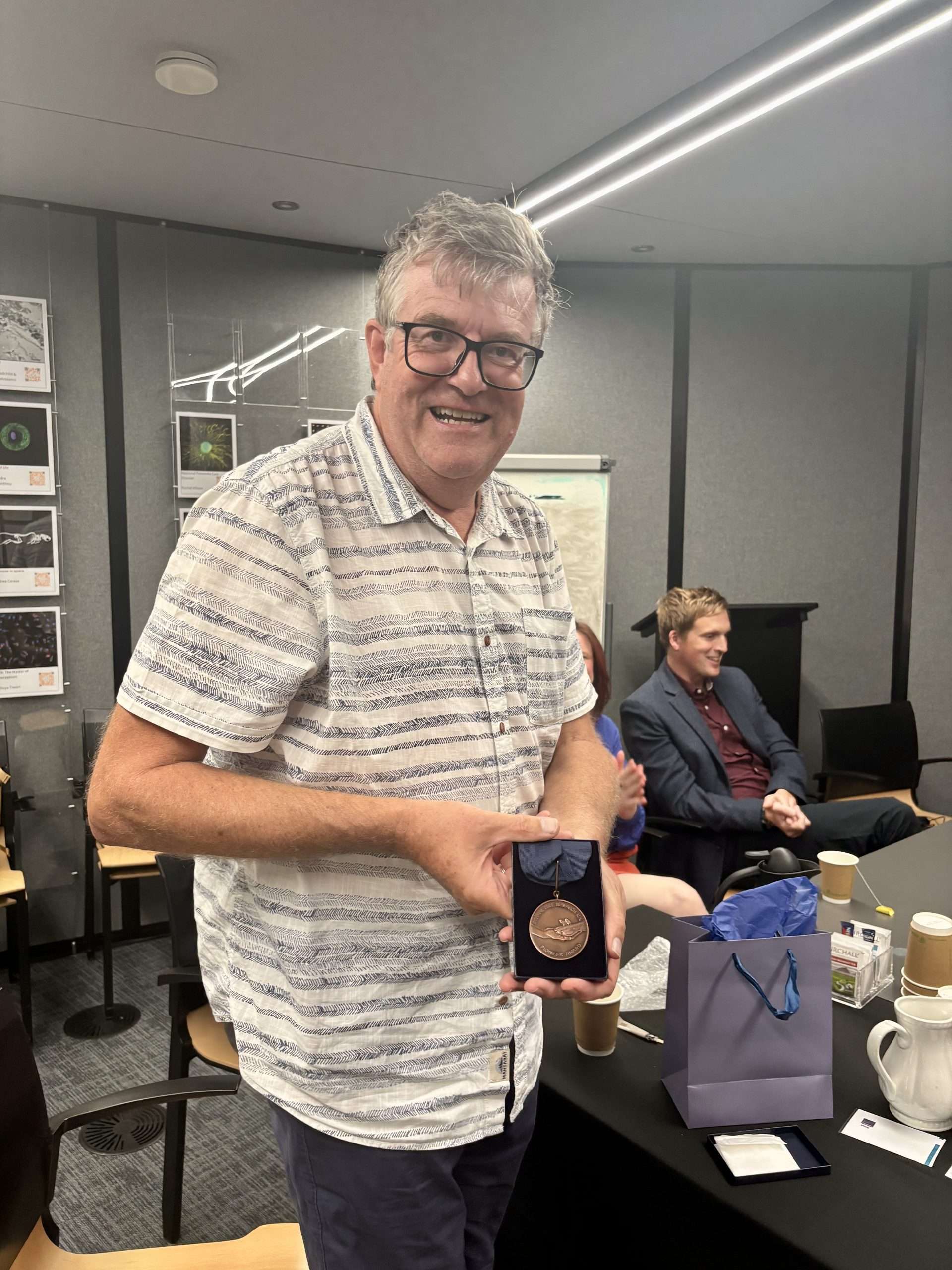 Professor Mike Philpott with his Pioneer Award medal